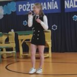 Dziewczyna śpiewająca na uroczystości zakończenia roku szkolnego w Będzinie. „Pożegnanie