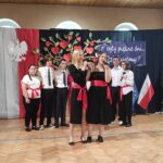Uczniowie śpiewają na uroczystości zakończenia roku szkolnego w Będzinie. Widoczny baner „To były piękne dni…”.